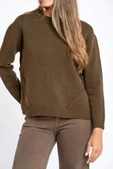 Sweater de lana color beige con diseño de motas multicolores, corte oversize, cuello redondo y puños y ruedo acanalados.
