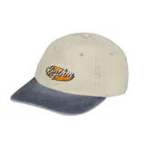 Gorra de béisbol con corona en color beige y visera en color gris. Presenta un logo bordado con la palabra 'Rhythm' sobre un fondo ovalado en el frente.