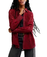 Camisa de manga larga color rojo oscuro, confeccionada en encaje floral con detalles en tela lisa (posiblemente satén) en el cuello, tapeta de botones y puños.