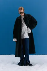Trench midi color negro, confeccionado en mezcla de algodón y nylon con acabado repelente al agua. Presenta diseño con tajos laterales, bolsillos internos y etiqueta de marca en la espalda.