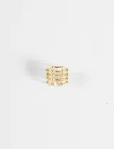 Earcuff metálico de cuatro vueltas con diseño de esferas pequeñas en los extremos.