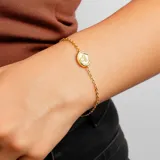 Pulsera dorada con cadena de eslabones finos y dije redondo con el signo zodiacal de Libra.