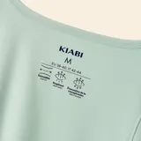 Camiseta deportiva de manga larga color verde menta, con diseño fluido y corte cropped. Presenta cuello redondo y aberturas para los pulgares en los puños.