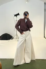 Pantalón de jean estilo wide leg color crudo, con diseño de costuras verticales y corte amplio desde la cadera hasta el ruedo.
