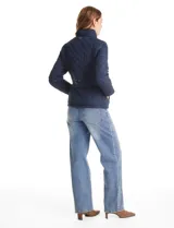 Campera capitoneada azul marino con diseño de rombos y paneles laterales elásticos para un ajuste entallado. Presenta cuello alto, cierre frontal completo y bolsillos laterales con cierre.
