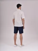 Camisa de manga corta color verde claro, con cuello clásico y cierre frontal con botones.