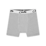 Boxer tipo bóxer de algodón gris jaspeado, con pretina elástica blanca que lleva el logo de la marca en negro.