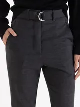 Pantalón de vestir color gris, de corte regular y largo tobillero. Presenta cintura alta con trabillas, cierre frontal con doble gancho y un cinturón desmontable con hebilla metálica.