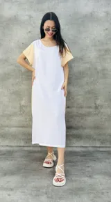 Vestido largo blanco con mangas cortas negras y corte holgado.