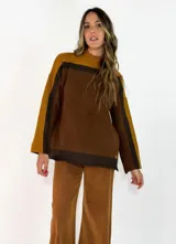 Sweater de punto con diseño de bloques de color en tonos marrón, mostaza y chocolate. Presenta cuello alto, mangas largas con corte caído y un ajuste holgado.