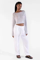 Sweater crop plateado de manga larga, tejido con hilo brillante con lurex, escote bote amplio y diseño relajado.
