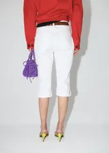 Pantalón de jean blanco estilo capri, con silueta slim y tiro regular, de corte ajustado y diseño clásico.