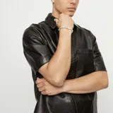 Pulsera de bolas plateadas con cuentas de cristal de Murano color marfil.