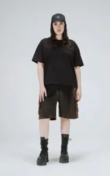 Bermuda estilo cargo oversize de algodón, con proceso de desgaste que genera un efecto degradado de negro a marrón óxido. Presenta recortes y bolsillos laterales con tapa.