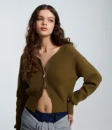 Cardigan de punto color verde militar, con cuello en V, mangas largas abullonadas y cierre frontal de cremallera bilateral.