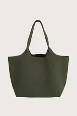 Bolso tipo tote de tejido de punto acanalado en color verde oliva, con diseño amplio y asas integradas. Incluye un pequeño neceser o monedero a juego sujeto por una correa con mosquetón.