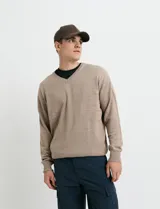 Sweater de punto color ladrillo con cuello en V y mangas largas.