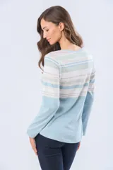 Remera de algodón con poliéster, de manga larga, con estampado de rayas horizontales en tonos beige, azul claro, azul grisáceo y blanco. Tiene un corte clásico y escote redondo.