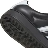 Championes Adidas Superstar XLG, modelo icónico con capellada de cuero negro, las clásicas tres tiras laterales en blanco y la característica puntera de goma blanca. Presenta una suela de plataforma negra que aporta altura y un estilo moderno.