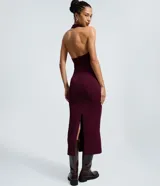 Vestido midi color bordó con textura, cuello halter y detalle de nudo con abertura en el busto.