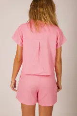 Camisa rosada de manga corta con cuello y corte holgado.