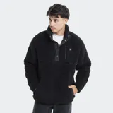 Campera de polar tipo sherpa color negro, con cuello alto, cierre frontal parcial con botones a presión y bolsillo en el pecho con logo de la marca.