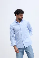 Camisa de manga larga fit semi slim color celeste, con cierre frontal de botones y cuello camisero clásico.