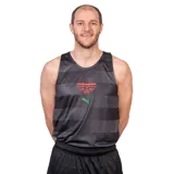 Musculosa deportiva del Club Atlético Aguada, modelo Away. Presenta un diseño de rayas horizontales en tonos negro y gris oscuro, con el escudo del club en color rojo en el pecho y el logo de Puma en verde.