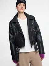 Chaqueta biker negra de cuero sintético con cierre asimétrico, cuello con solapas y múltiples bolsillos con cremallera.