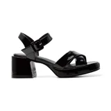 Sandalias negras de charol con plataforma y taco cuadrado. Tiras anchas cruzadas sobre el empeine y pulsera con hebilla al tobillo.