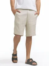 Bermuda de lino color azul marino, de corte recto y largo a la rodilla. Presenta bolsillos laterales y cierre frontal.