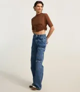 Remera negra de algodón, corte amplio, cuello alto en punto roma y mangas cortas.