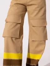 Pantalón cargo wide color beige confeccionado en denim 100% algodón. Posee recortes y bolsillos grandes con tapa en ambas piernas.