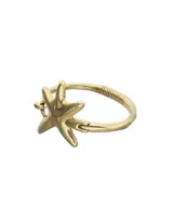 Pulsera rígida de metal dorado con diseño de estrella de mar y detalle de resorte.