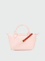 Cartera de mano Longchamp modelo Le Pliage Xs en color rosado, confeccionada en cuero con asas superiores, solapa con broche de presión y herrajes metálicos dorados.