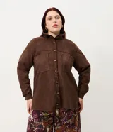 Camisa tipo overshirt de Ashua confeccionada en suede sintético color marrón. Presenta cuello clásico, cierre frontal con botones, mangas largas con puños abotonados y dos bolsillos frontales aplicados.