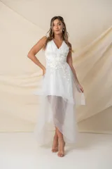 Vestido de fiesta blanco de tul con volados irregulares e incrustaciones de flores y hojas bordadas en hilo de seda en color blanco, crudo y dorado.