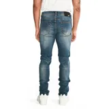 Jeans skinny para hombre, de corte ajustado y diseño de cinco bolsillos, con cierre de cremallera y botón metálico. Presenta un lavado azul medio con efecto desgastado.