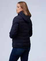 Campera negra impermeable de abrigo, marca Michael Kors. Tiene capucha no desmontable con jareta de ajuste, cierre metálico central, bolsillos verticales delanteros y puños elastizados.