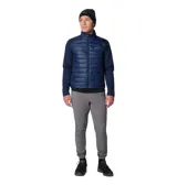 Chaqueta híbrida Columbia con panel frontal acolchado y mangas de tejido softshell liso. Cuenta con cierre frontal completo, cuello alto y bolsillos laterales con cierre. Diseño técnico con tecnología Omni-Shield repelente al agua y aislamiento térmico sintético.