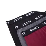 Pack de tres boxers de algodón con cintura elástica ancha que presenta el logo de la marca Rusty estampado en blanco. El set incluye un boxer negro, uno gris melange y uno bordó.