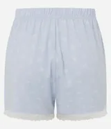 Short de pijama celeste de peach touch con estampa de moñitas blancas, cintura elastizada con bragueta frontal de botones y detalle de encaje blanco en los bajos.