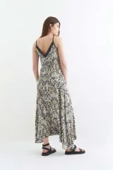 Mono largo con estampado floral en tonos beige, escote en V y tirantes finos.