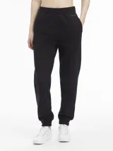 Pantalón de jogging negro con puños elásticos, cintura elástica con cordón ajustable y logo de Calvin Klein en la pierna izquierda.