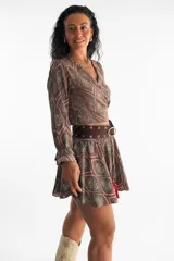 Conjunto de dos piezas marrón con estampado paisley, compuesto por un top cruzado de manga larga con volados en los puños y un short pollera corto y fluido.