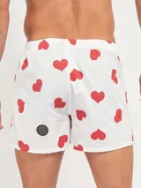 Bóxer de algodón blanco con estampado de flores pequeñas color celeste, con cintura elástica y logo de la marca en el centro.