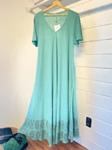 Vestido largo color crema de algodón con mangas cortas amplias, escote en V y estampado geométrico en el ruedo.