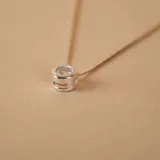 Conjunto de collar y aros tipo punto de luz, confeccionado en plata 925 con engaste de circonia central.