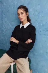 Sweater blanco de punto con diseño holgado, cuello redondo, mangas largas acampanadas y detalles de textura horizontal en el tejido.