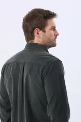 Camisa de manga larga confeccionada en pana fina de algodón, con cuello camisero, cierre frontal de botones y un bolsillo aplicado en el pecho.